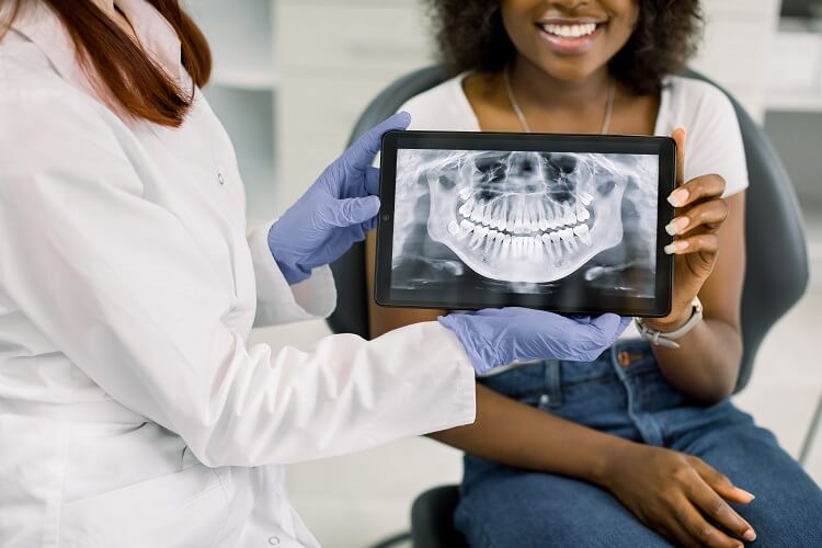 Dentista mostrando radiografia para paciente