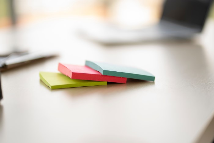 Post-its coloridos em cima de uma escrivaninha.