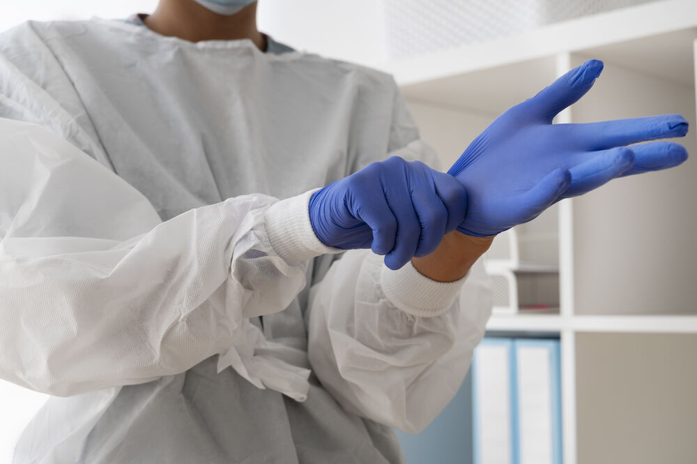 side-view-doctor-putting-protection-gloves.jpg